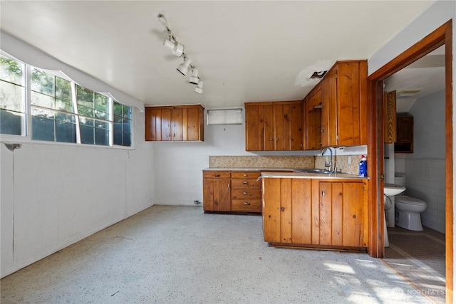1203 S 8th Ave, Yakima, WA 98902 - kitchen featuring brown cabinetry, light countertops, a peninsula, and track lighting