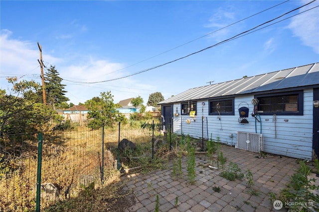 1203 S 8th Ave, Yakima, WA 98902 - rear view of house with a standing seam roof, a metal roof, and a patio area