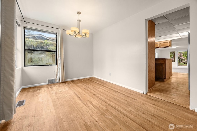 15557 Ashworth Ave N, Shoreline, WA 98133 - unfurnished room featuring a chandelier, wood finished floors, and baseboards