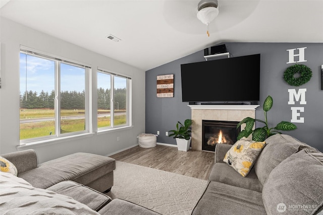 167 Goldmyer Dr, Chehalis, WA 98532 - living area with ceiling fan, wood finished floors, vaulted ceiling, a tile fireplace, and baseboards
