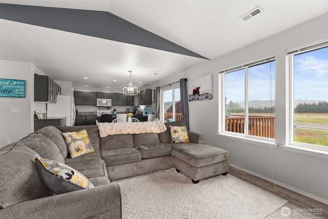 167 Goldmyer Dr, Chehalis, WA 98532 - living area with light wood finished floors, lofted ceiling, a chandelier, baseboards, and recessed lighting