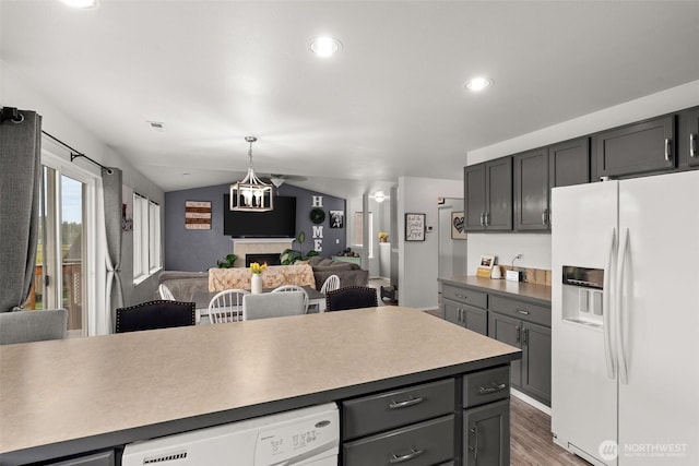 167 Goldmyer Dr, Chehalis, WA 98532 - kitchen featuring white appliances, open floor plan, wood finished floors, a fireplace, and lofted ceiling