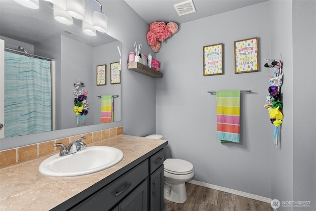 167 Goldmyer Dr, Chehalis, WA 98532 - full bathroom featuring vanity, toilet, wood finished floors, and baseboards