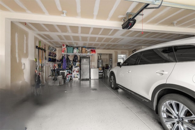 167 Goldmyer Dr, Chehalis, WA 98532 - garage featuring freestanding refrigerator, a garage door opener, and strapped water heater