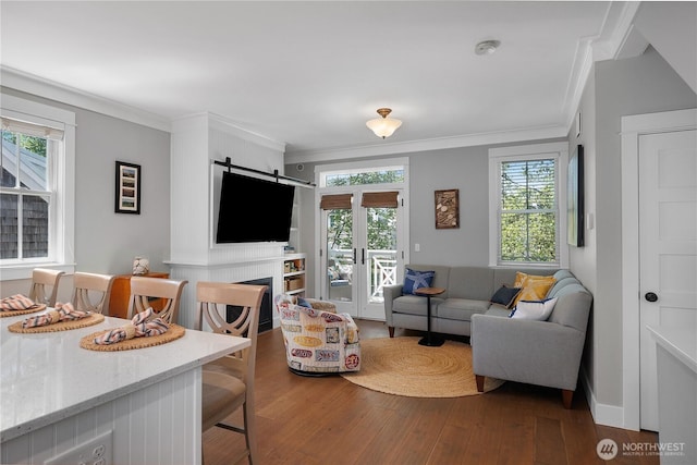 29 Laurel Ln, Pacific Beach, WA 98571 - living room with dark wood-style floors, healthy amount of natural light, crown molding, and a barn door