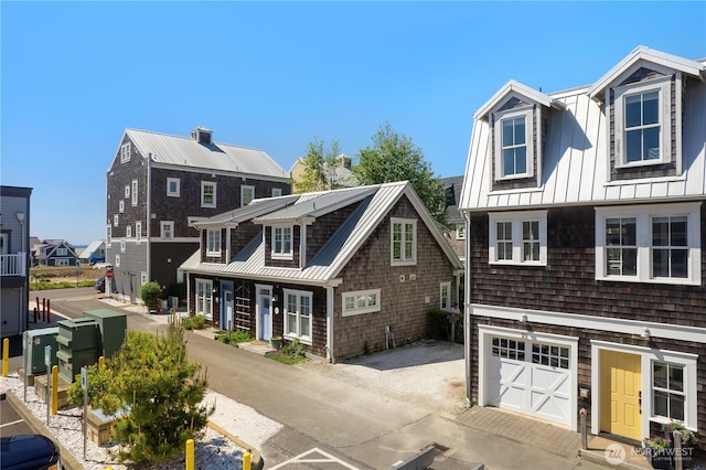 29 Laurel Ln, Pacific Beach, WA 98571 - view of front facade featuring metal roof, a standing seam roof, a garage, and driveway