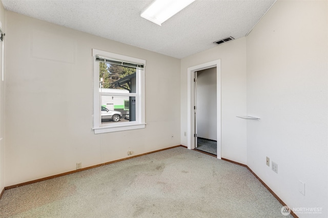 1023 W Stewart Ave, Puyallup, WA 98371 - carpeted spare room with a textured ceiling and baseboards