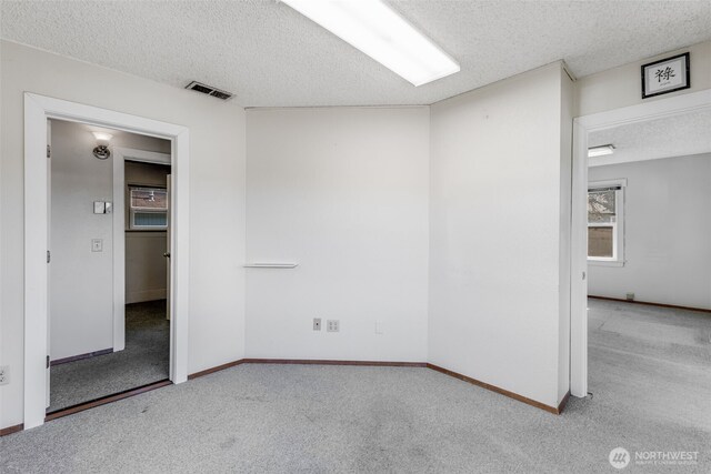 1023 W Stewart Ave, Puyallup, WA 98371 - carpeted empty room featuring a textured ceiling and baseboards