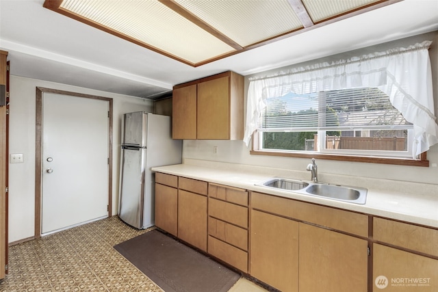 1023 W Stewart Ave, Puyallup, WA 98371 - kitchen featuring a sink, freestanding refrigerator, light floors, and light countertops