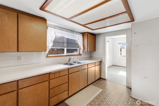 1023 W Stewart Ave, Puyallup, WA 98371 - kitchen featuring a sink, tile patterned floors, light countertops, and baseboards
