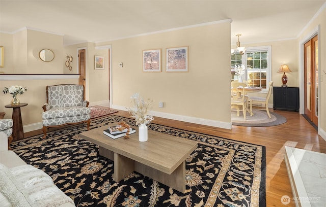 8724 Main St, Edmonds, WA 98026 - living area with wood finished floors, crown molding, baseboards, and a chandelier