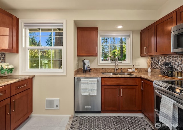 8724 Main St, Edmonds, WA 98026 - kitchen featuring stainless steel appliances, a sink, light stone countertops, healthy amount of natural light, and recessed lighting