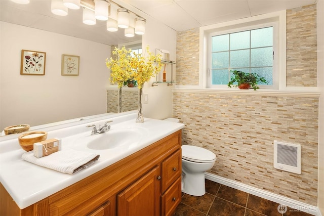 8724 Main St, Edmonds, WA 98026 - bathroom with heating unit, vanity, toilet, and tile patterned floors