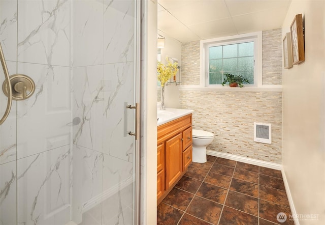 8724 Main St, Edmonds, WA 98026 - bathroom featuring a marble finish shower, heating unit, vanity, toilet, and baseboards