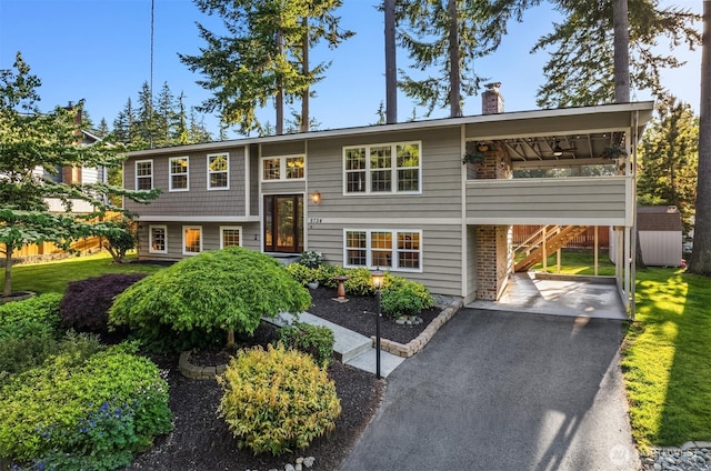 8724 Main St, Edmonds, WA 98026 - raised ranch with a ceiling fan, a chimney, asphalt driveway, and stairs
