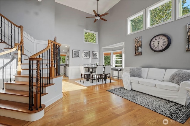 13374 SE 308th Ct, Auburn, WA 98092 - living area with ceiling fan, stairway, wood finished floors, ornamental molding, and a wainscoted wall