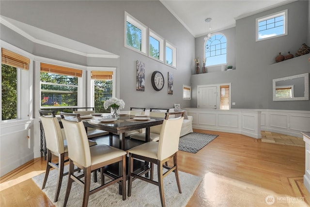 13374 SE 308th Ct, Auburn, WA 98092 - dining space with crown molding, a towering ceiling, and light wood finished floors