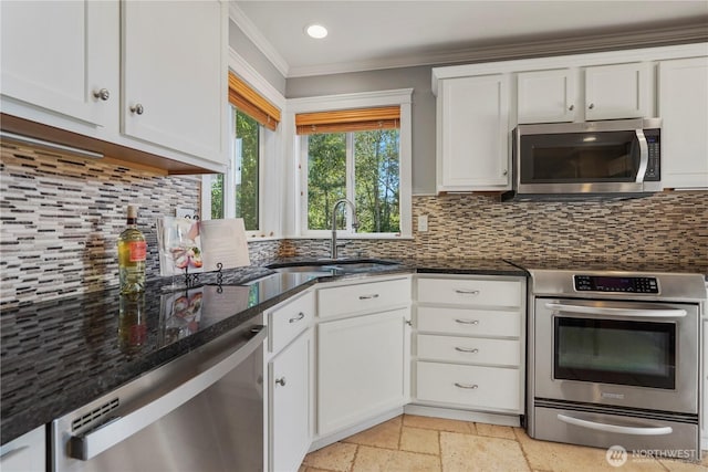 13374 SE 308th Ct, Auburn, WA 98092 - kitchen featuring appliances with stainless steel finishes, a sink, ornamental molding, white cabinets, and stone tile floors