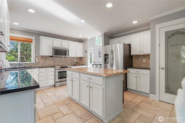 13374 SE 308th Ct, Auburn, WA 98092 - kitchen featuring appliances with stainless steel finishes, ornamental molding, a sink, decorative backsplash, and stone tile flooring