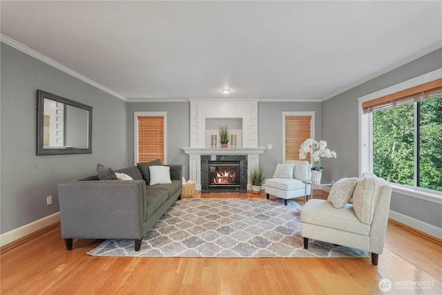 13374 SE 308th Ct, Auburn, WA 98092 - living room featuring baseboards, light wood-style floors, crown molding, a high end fireplace, and built in features