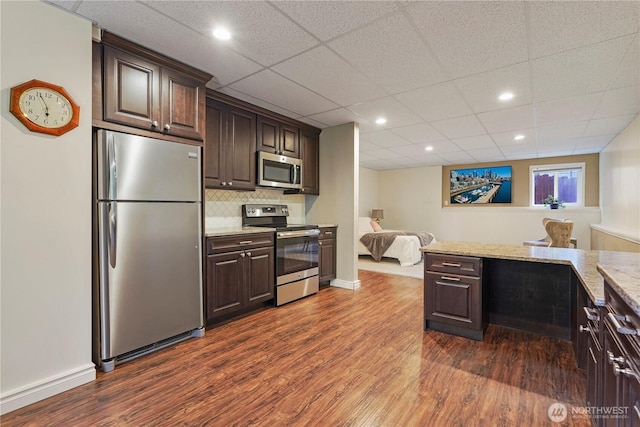 13374 SE 308th Ct, Auburn, WA 98092 - kitchen with stainless steel appliances, dark brown cabinetry, dark wood-type flooring, light stone countertops, and recessed lighting