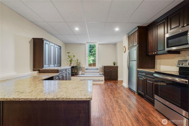 13374 SE 308th Ct, Auburn, WA 98092 - kitchen featuring appliances with stainless steel finishes, a drop ceiling, dark brown cabinetry, dark wood-style flooring, and recessed lighting