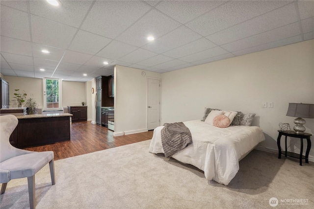 13374 SE 308th Ct, Auburn, WA 98092 - bedroom featuring dark carpet, dark wood finished floors, freestanding refrigerator, a paneled ceiling, and recessed lighting