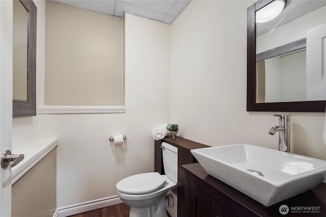 13374 SE 308th Ct, Auburn, WA 98092 - half bath with toilet, wood finished floors, a drop ceiling, baseboards, and vanity
