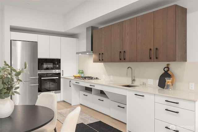 999 110th Ave NE Unit 202, Bellevue, WA 98004 - kitchen with black appliances, wall chimney range hood, a sink, light countertops, and white cabinetry
