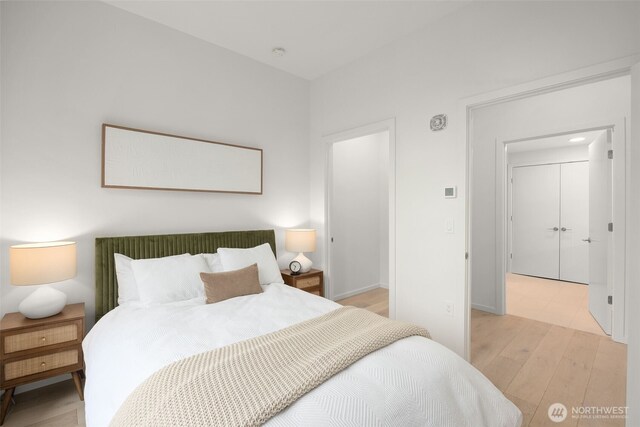 999 110th Ave NE Unit 202, Bellevue, WA 98004 - bedroom featuring light wood-style flooring and baseboards