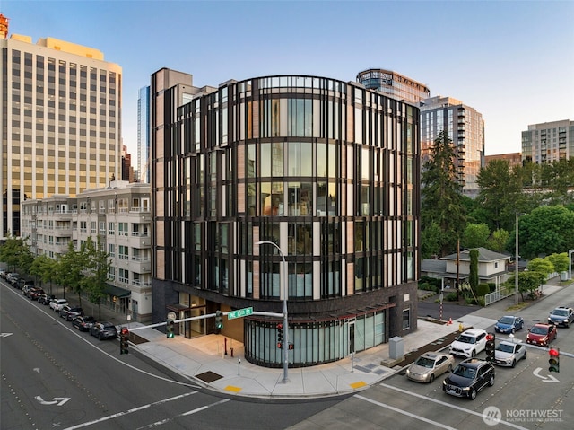 999 110th Ave NE Unit 202, Bellevue, WA 98004 - view of building exterior with a view of city and uncovered parking