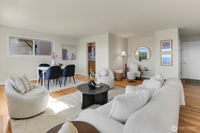 330 W Olympic Pl Unit 302, Seattle, WA 98119 - living area featuring light wood-style flooring and baseboards