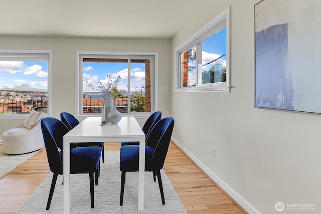 330 W Olympic Pl Unit 302, Seattle, WA 98119 - dining space with wood finished floors and baseboards
