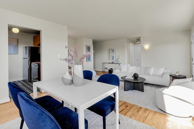 330 W Olympic Pl Unit 302, Seattle, WA 98119 - dining room featuring light wood-style floors and baseboards