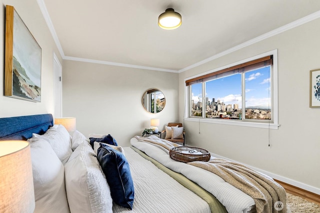 330 W Olympic Pl Unit 302, Seattle, WA 98119 - bedroom featuring crown molding, baseboards, and wood finished floors