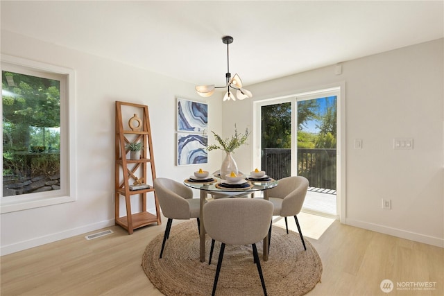 5134 S Wallace St, Seattle, WA 98178 - dining area featuring a chandelier, light wood-type flooring, and baseboards