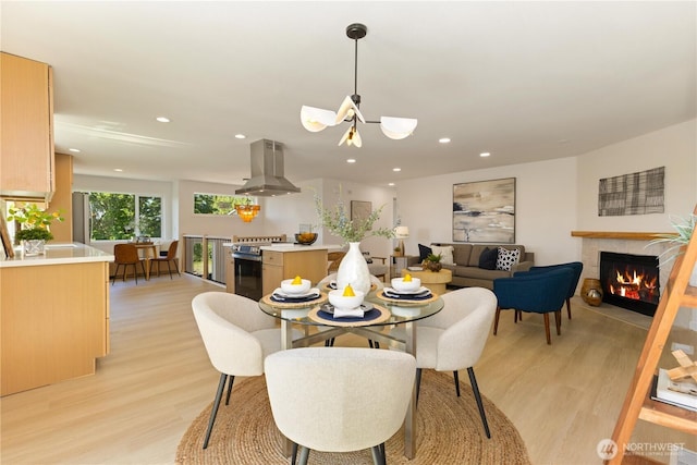 5134 S Wallace St, Seattle, WA 98178 - dining area featuring light wood finished floors, a lit fireplace, and recessed lighting