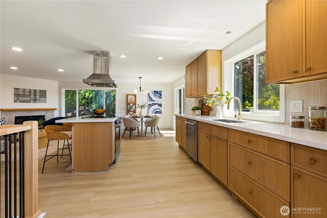5134 S Wallace St, Seattle, WA 98178 - kitchen with a sink, island range hood, stainless steel dishwasher, light wood-style floors, and a kitchen breakfast bar