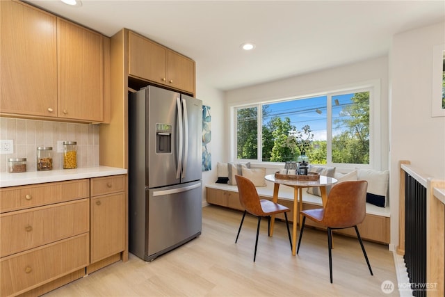 5134 S Wallace St, Seattle, WA 98178 - kitchen with breakfast area, stainless steel fridge, light countertops, light wood-style floors, and decorative backsplash