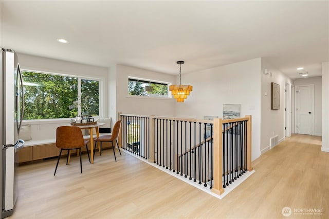 5134 S Wallace St, Seattle, WA 98178 - corridor with light wood-style flooring, an upstairs landing, recessed lighting, a chandelier, and electric panel