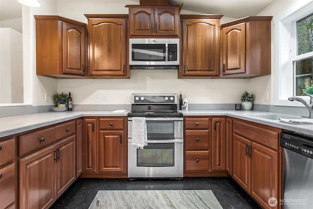 110 E Sea Breeze Dr, Grapeview, WA 98546 - kitchen featuring stainless steel appliances, a sink, light countertops, and brown cabinets