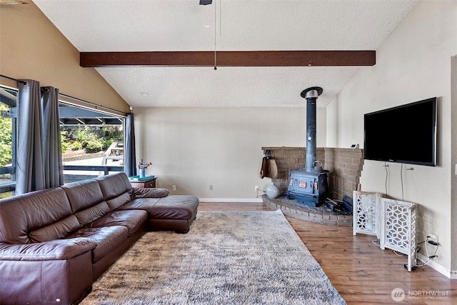 268 Kingsway W, Bremerton, WA 98312 - living room with wood finished floors, a wood stove, and a textured ceiling