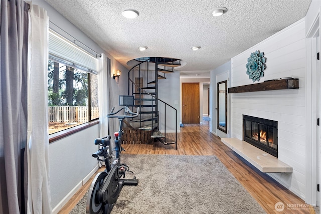 268 Kingsway W, Bremerton, WA 98312 - exercise area featuring a textured ceiling, wood finished floors, and a glass covered fireplace