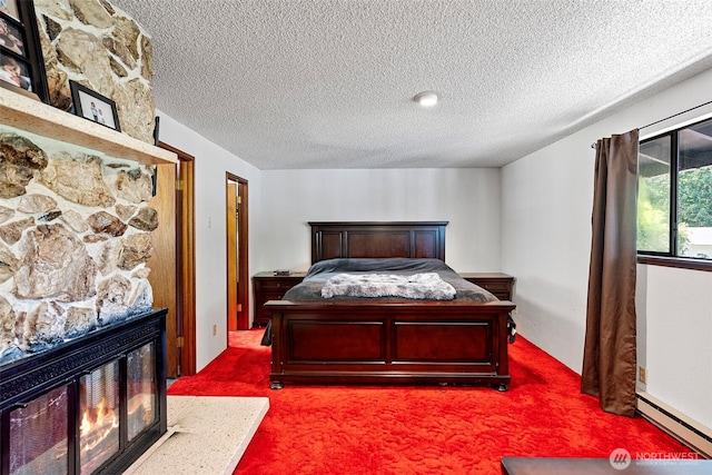 268 Kingsway W, Bremerton, WA 98312 - bedroom featuring a textured ceiling, carpet floors, a stone fireplace, and a baseboard radiator