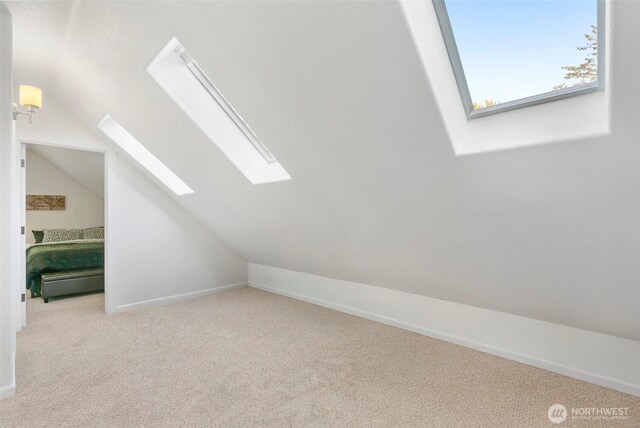 34821 NE Gable Ave, La Center, WA 98629 - additional living space with a skylight, lofted ceiling, and carpet flooring