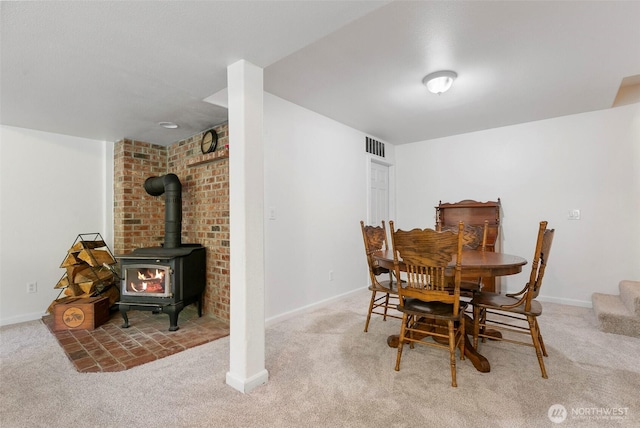 34821 NE Gable Ave, La Center, WA 98629 - carpeted dining area with a wood stove and baseboards