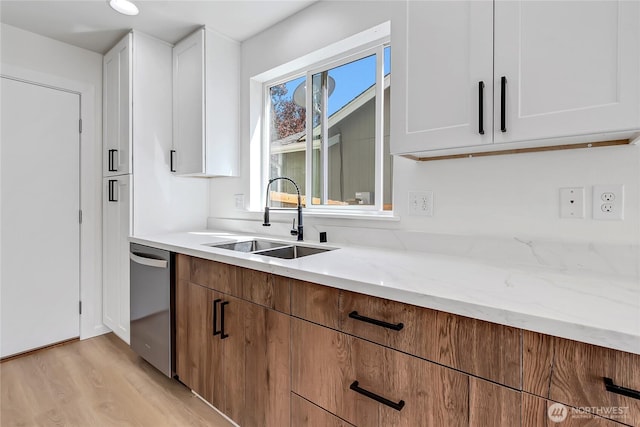20610 6th Avenue Ct E, Spanaway, WA 98387 - kitchen featuring dishwasher, a sink, light wood-style floors, white cabinetry, and light stone counters