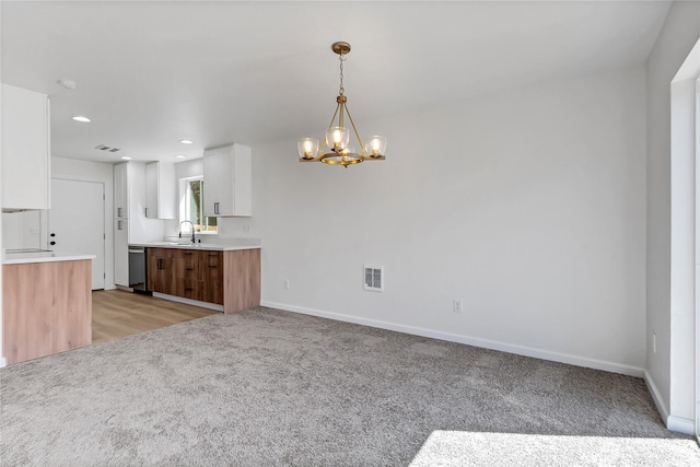 20610 6th Avenue Ct E, Spanaway, WA 98387 - kitchen with light colored carpet, white cabinetry, a chandelier, dishwasher, and recessed lighting