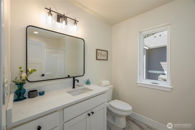 11 Kinglet Ct, Bellingham, WA 98229 - bathroom with marble look tile flooring, vanity, toilet, and baseboards