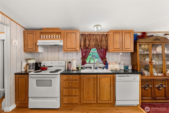 1201 8th St, Vader, WA 98593 - kitchen with white appliances, under cabinet range hood, a sink, dark countertops, and wallpapered walls